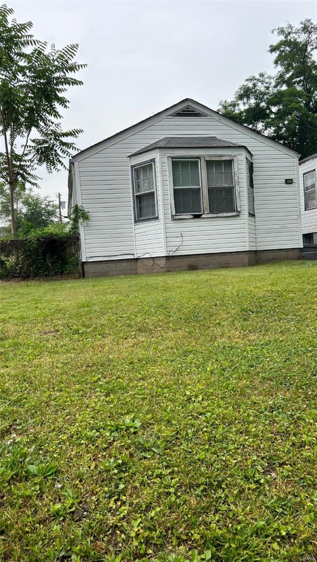 view of home's exterior with a lawn