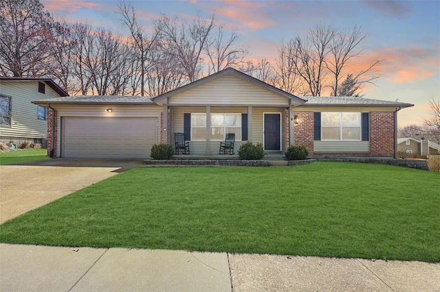 ranch-style house with brick siding, covered porch, a lawn, a garage, and driveway