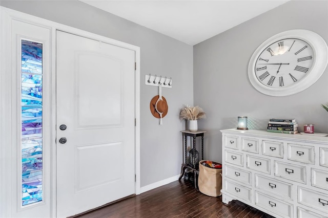 foyer with baseboards and dark wood-style flooring