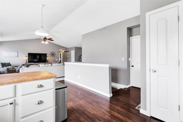 kitchen with a ceiling fan, dark wood-style floors, white cabinets, light countertops, and lofted ceiling