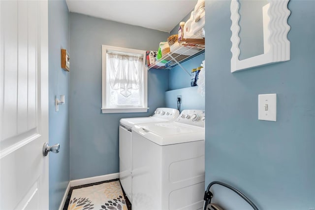 washroom with laundry area, independent washer and dryer, and baseboards