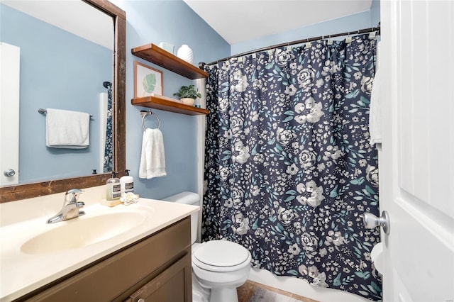 bathroom featuring a shower with curtain, toilet, and vanity