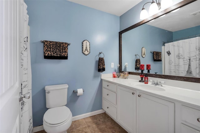 bathroom featuring visible vents, baseboards, toilet, tile patterned floors, and vanity