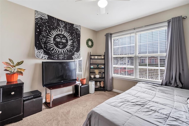 bedroom with a ceiling fan, carpet, and baseboards