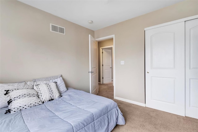 bedroom with carpet, visible vents, and baseboards