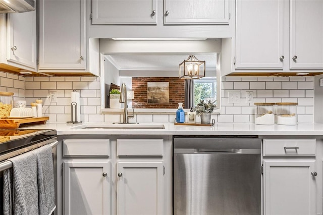 kitchen featuring light countertops, stainless steel dishwasher, and crown molding