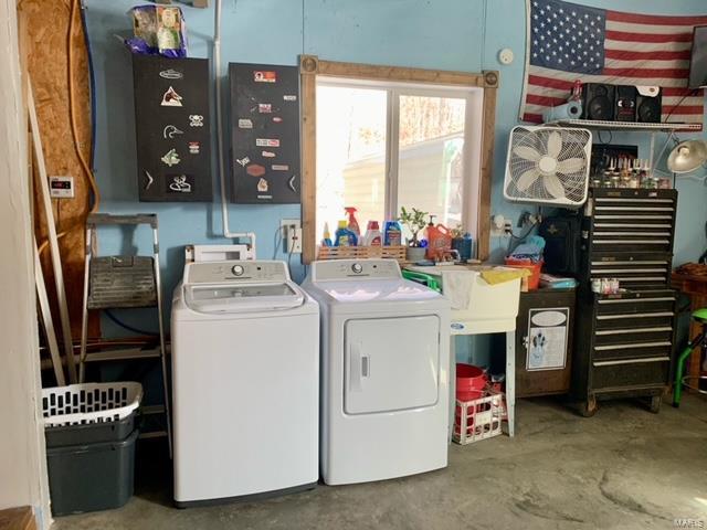 laundry area featuring washing machine and clothes dryer