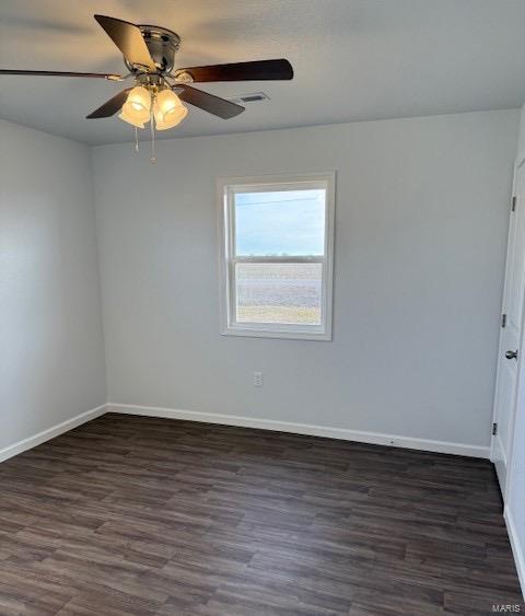 empty room with dark wood-type flooring and ceiling fan