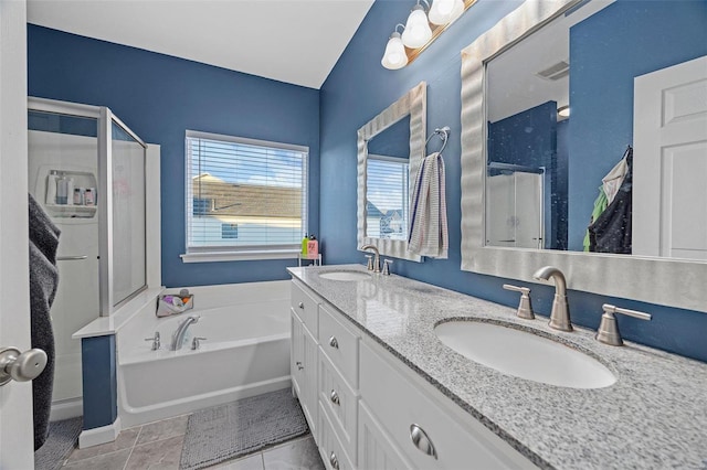 bathroom featuring a garden tub, a sink, visible vents, and tile patterned floors