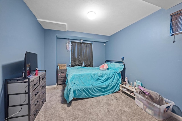 bedroom with baseboards and light colored carpet