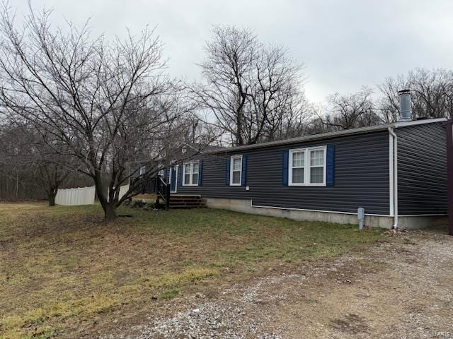 view of side of home featuring a lawn