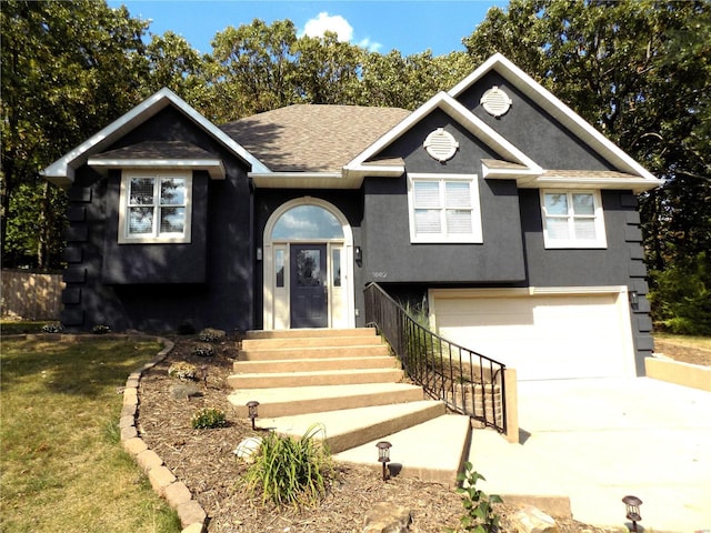 view of front of property with a garage, concrete driveway, a shingled roof, and stucco siding