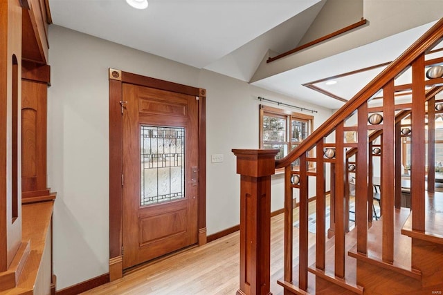 entryway featuring light hardwood / wood-style flooring and vaulted ceiling