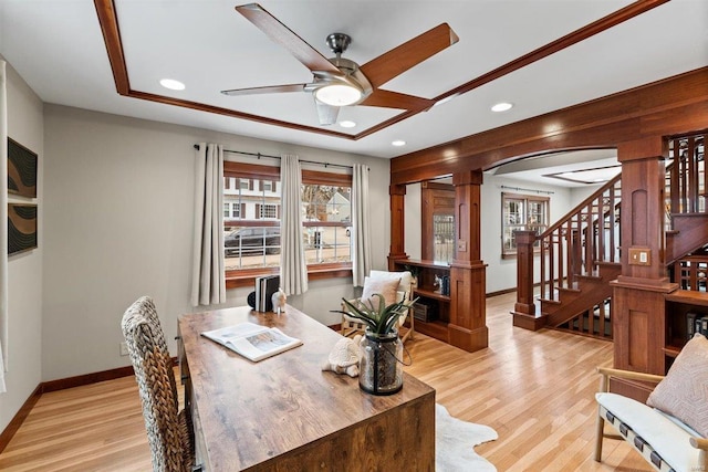 office space with ceiling fan, decorative columns, and light hardwood / wood-style floors