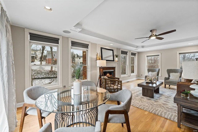 interior space with crown molding, light hardwood / wood-style floors, and a raised ceiling