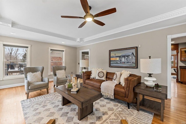 living room featuring ceiling fan, light wood-type flooring, and crown molding