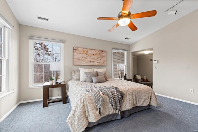 bedroom featuring carpet floors, rail lighting, and ceiling fan