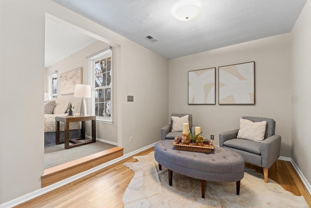 sitting room with hardwood / wood-style flooring