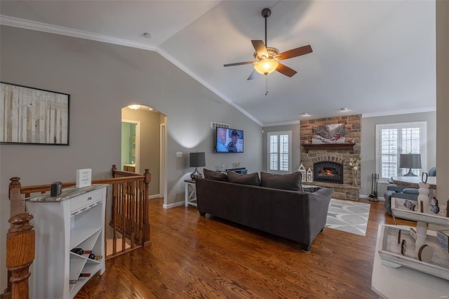 living room featuring ornamental molding, vaulted ceiling, dark hardwood / wood-style floors, and a healthy amount of sunlight