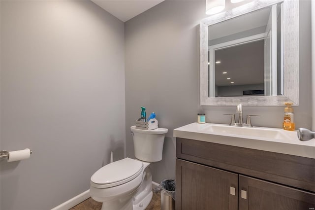 bathroom with toilet and vanity