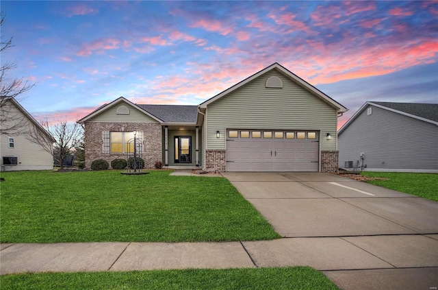 view of front of property featuring a garage and a lawn