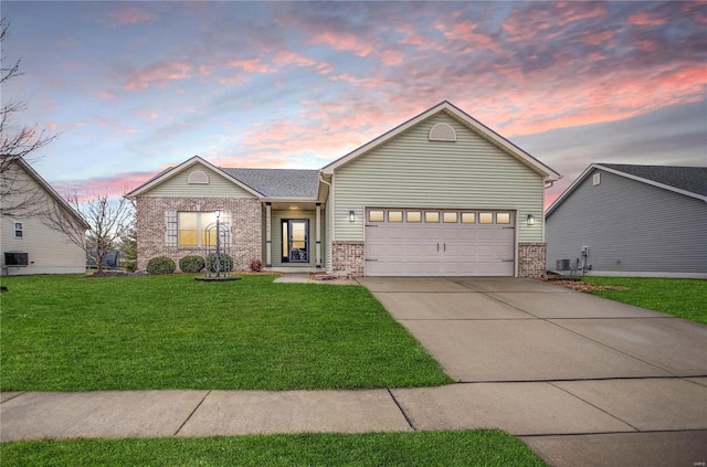 view of front of house with a garage and a lawn