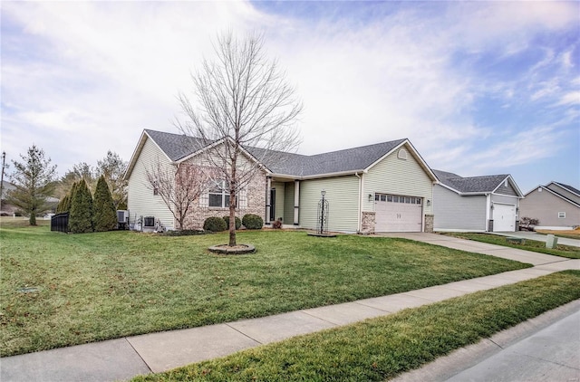 ranch-style home featuring a front lawn and a garage