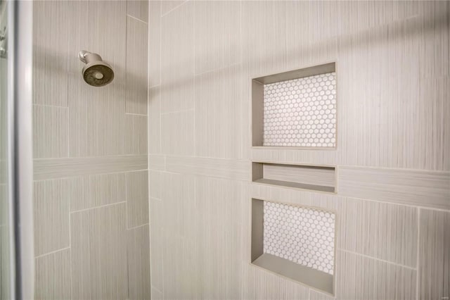 interior details with a tile shower