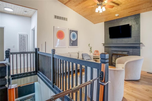 interior space featuring vaulted ceiling, hardwood / wood-style floors, and wooden ceiling