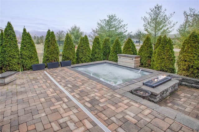 view of pool with a patio and a fire pit