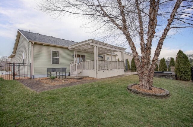 rear view of house featuring a lawn and a pergola