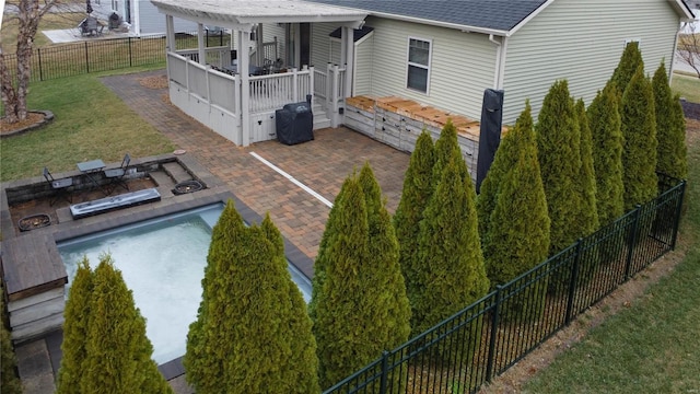 back of house with a patio, a fenced in pool, and a yard