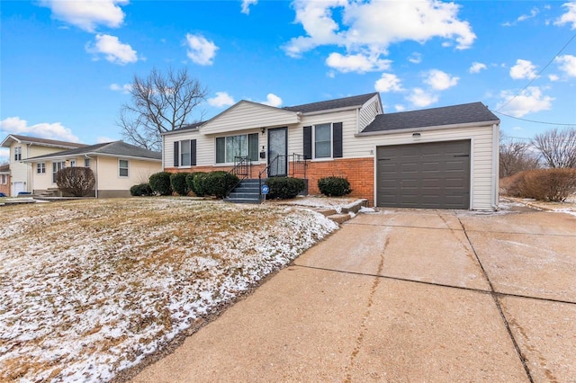 single story home with a garage, driveway, and brick siding