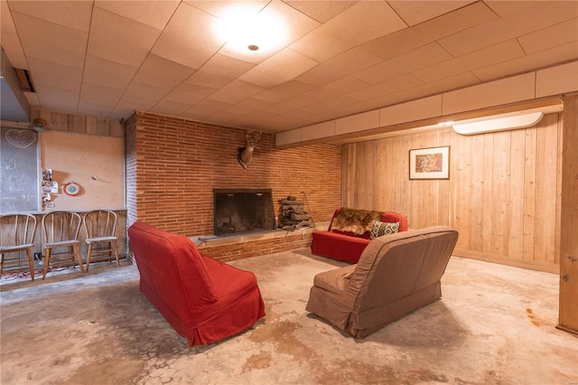 living room featuring wood walls and concrete floors