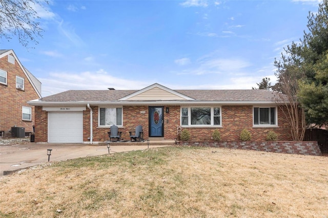 single story home featuring a front lawn, a garage, and cooling unit