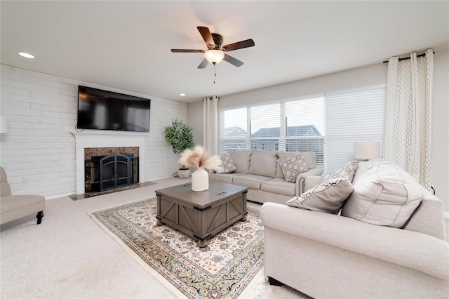 carpeted living room featuring ceiling fan