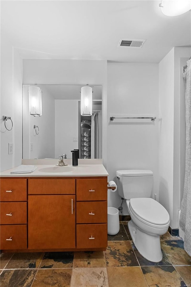 bathroom featuring vanity and toilet