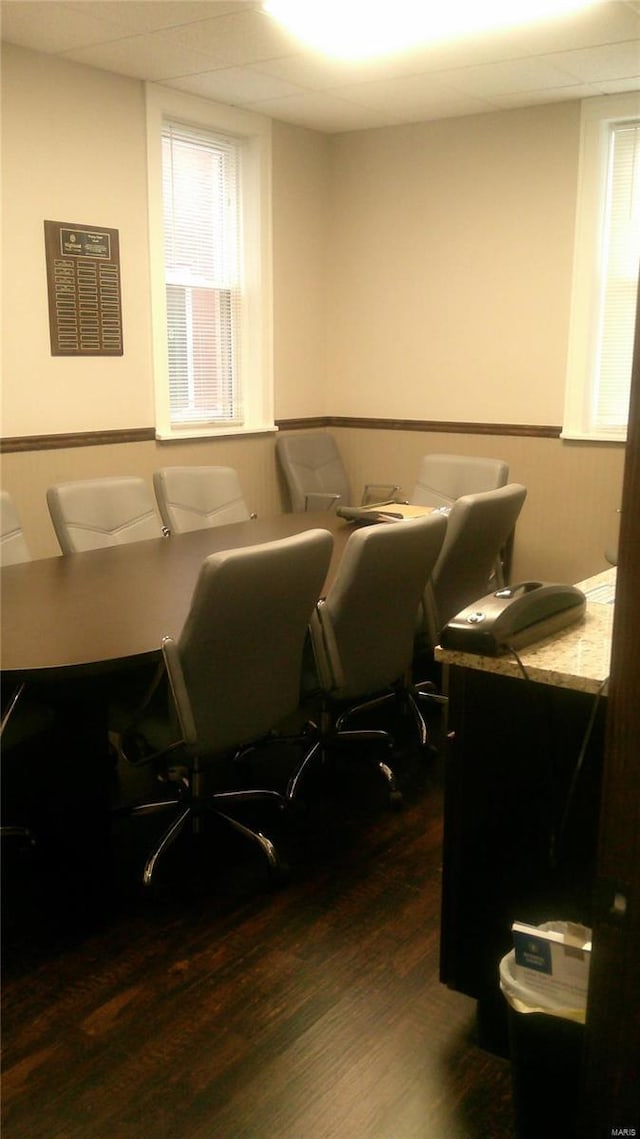 home office with dark hardwood / wood-style floors