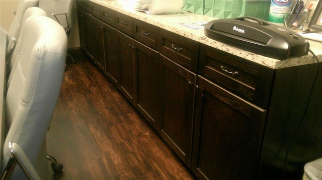 kitchen featuring light stone counters and dark hardwood / wood-style floors