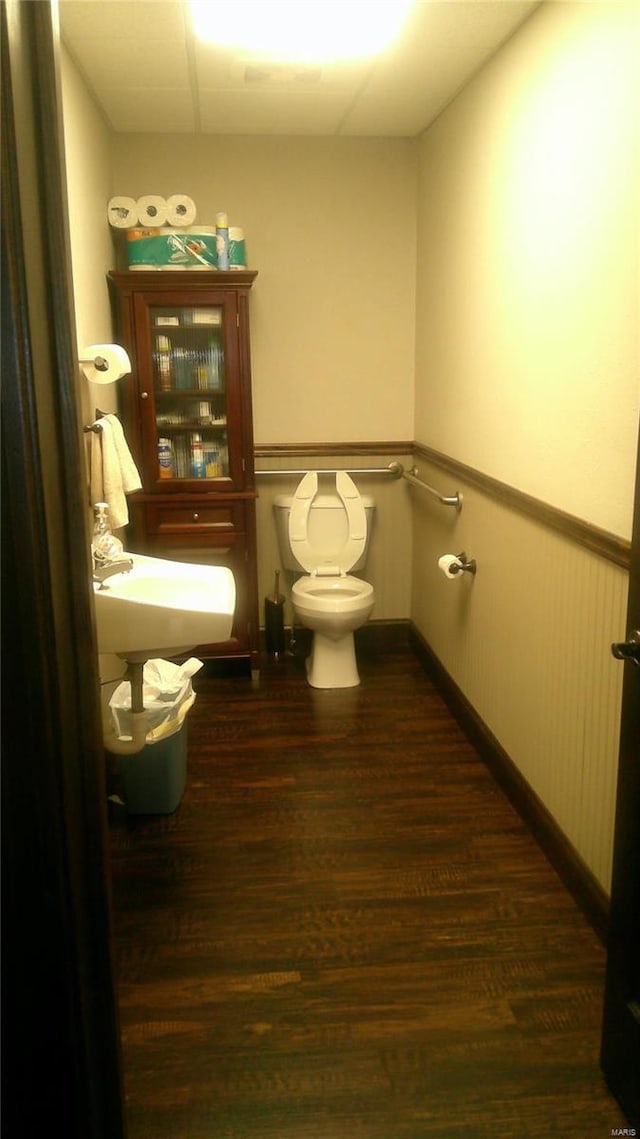 bathroom featuring hardwood / wood-style floors and toilet