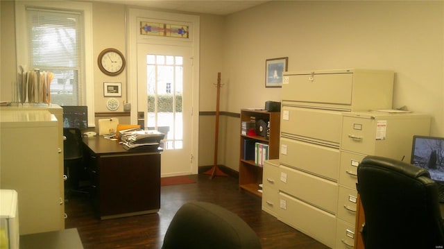 office area with plenty of natural light and dark hardwood / wood-style floors