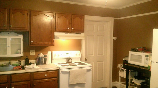 kitchen featuring ornamental molding and white appliances