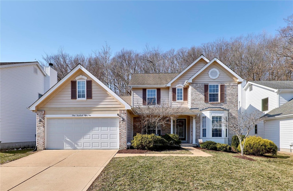 traditional-style home with driveway, brick siding, a garage, and a front yard