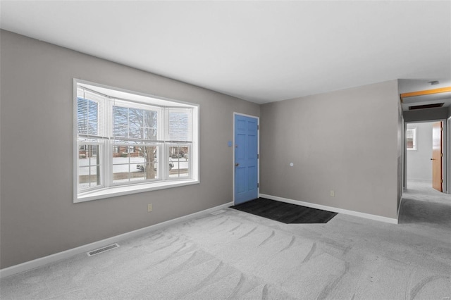 carpeted entrance foyer featuring baseboards and visible vents