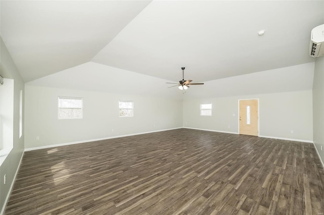 additional living space featuring plenty of natural light, baseboards, dark wood-type flooring, and a ceiling fan