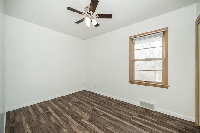 empty room with visible vents, dark wood finished floors, baseboards, and ceiling fan