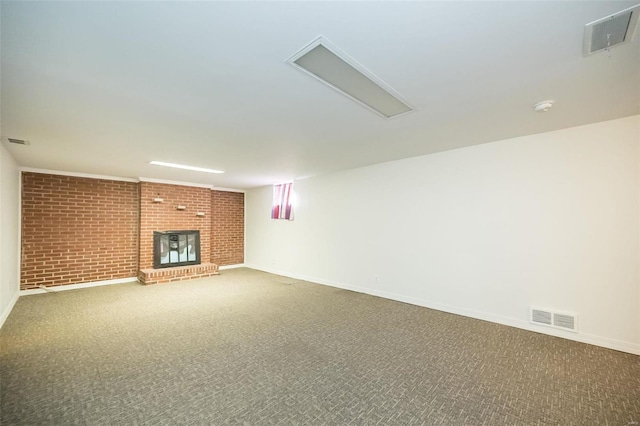 unfurnished living room with brick wall, carpet, a fireplace, and visible vents