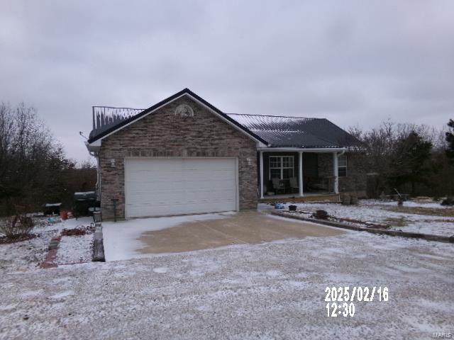 single story home featuring a garage and driveway