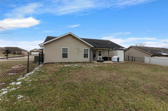 rear view of property featuring a lawn and a patio area