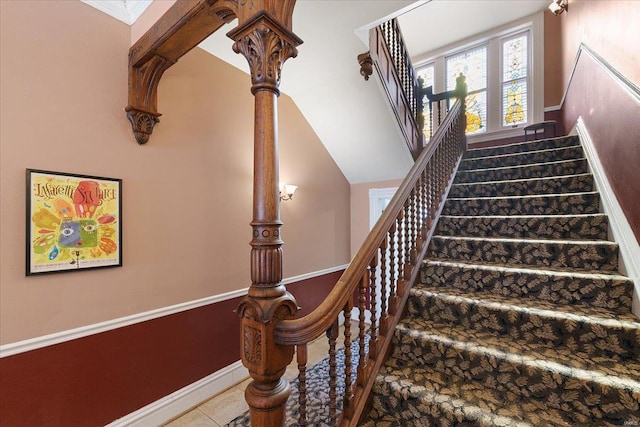 stairway with baseboards and tile patterned floors